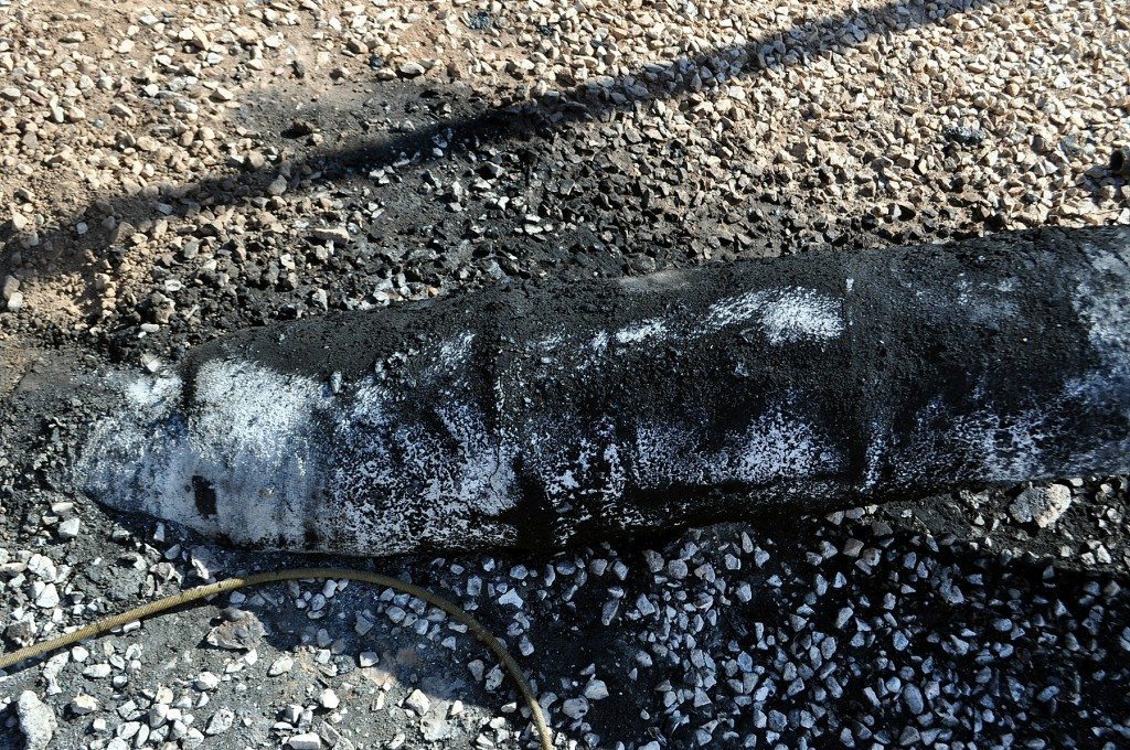 G2MT Labs Fire damage assessment close-up view of charred composite wrap on line looking South